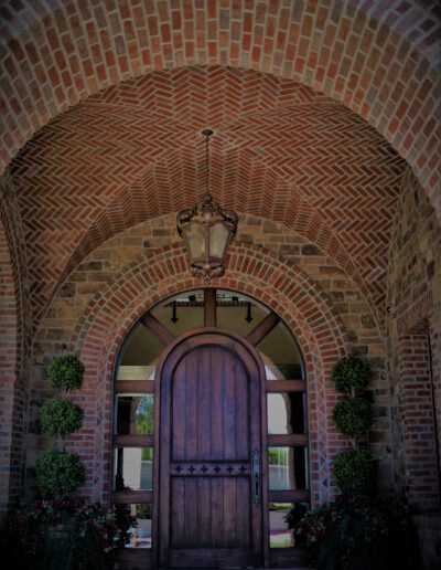 A brick archway with a wooden door.